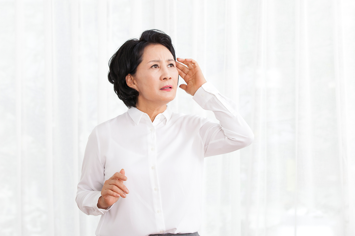 머리 짚고 있는 중년 여성